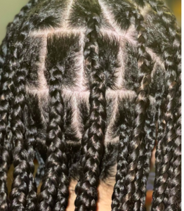 Large, black box braid extensions in a bricklayer pattern.